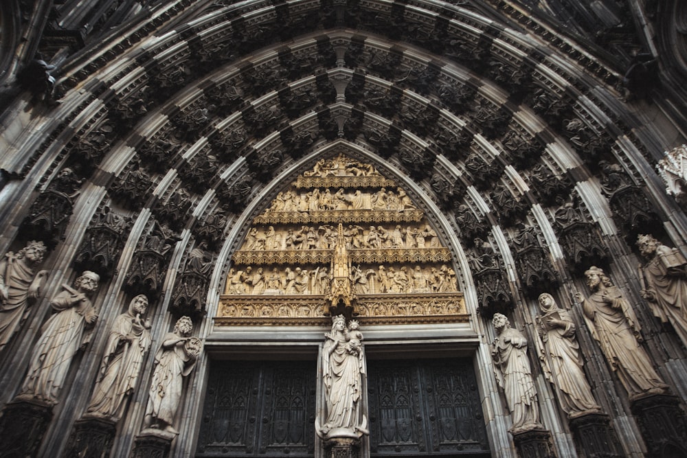 a large cathedral with statues on the front of it