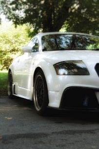 A sleek car parked in a driveway, representing vehicle insurance coverage.