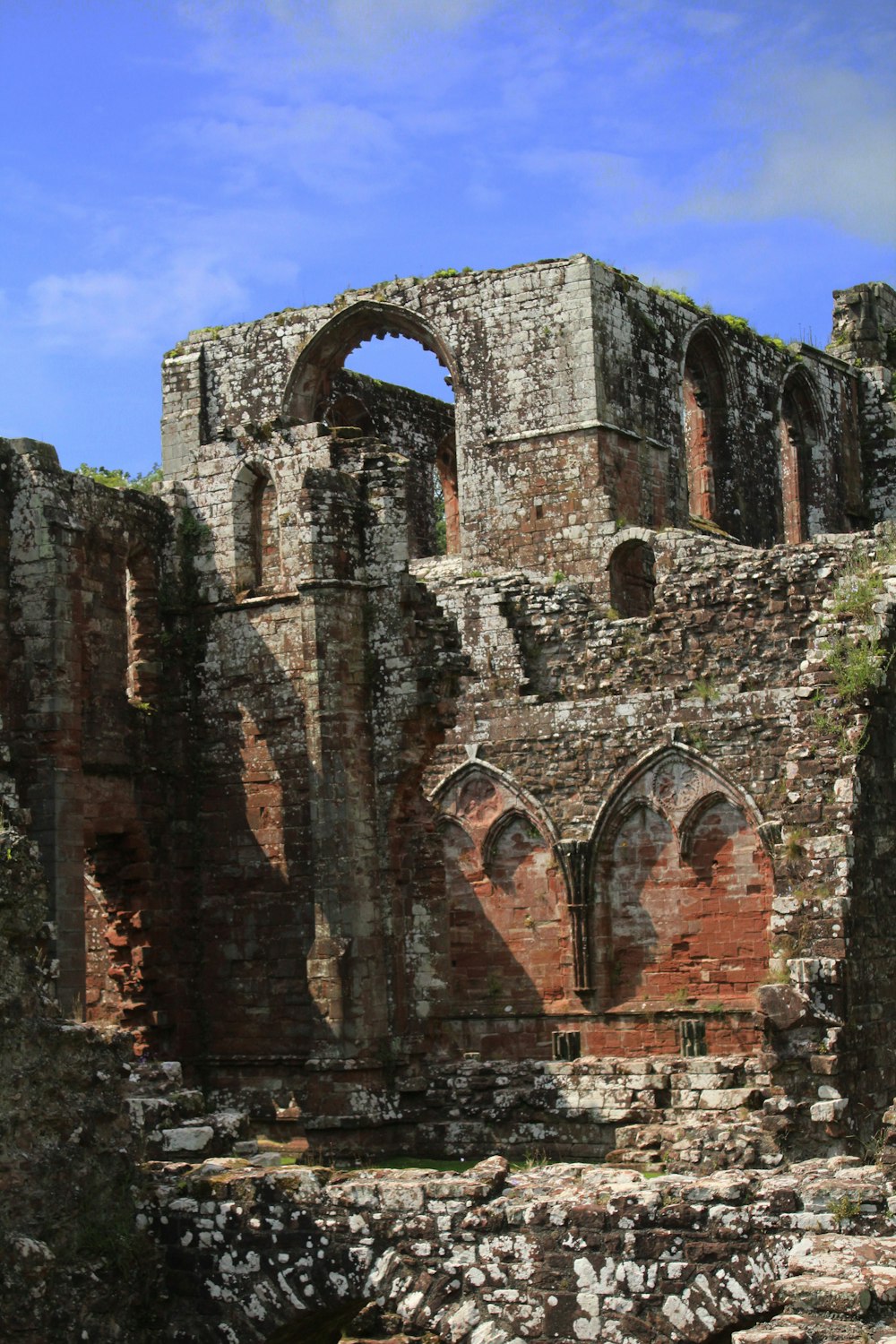 the ruins of an old building with a blue sky in the background