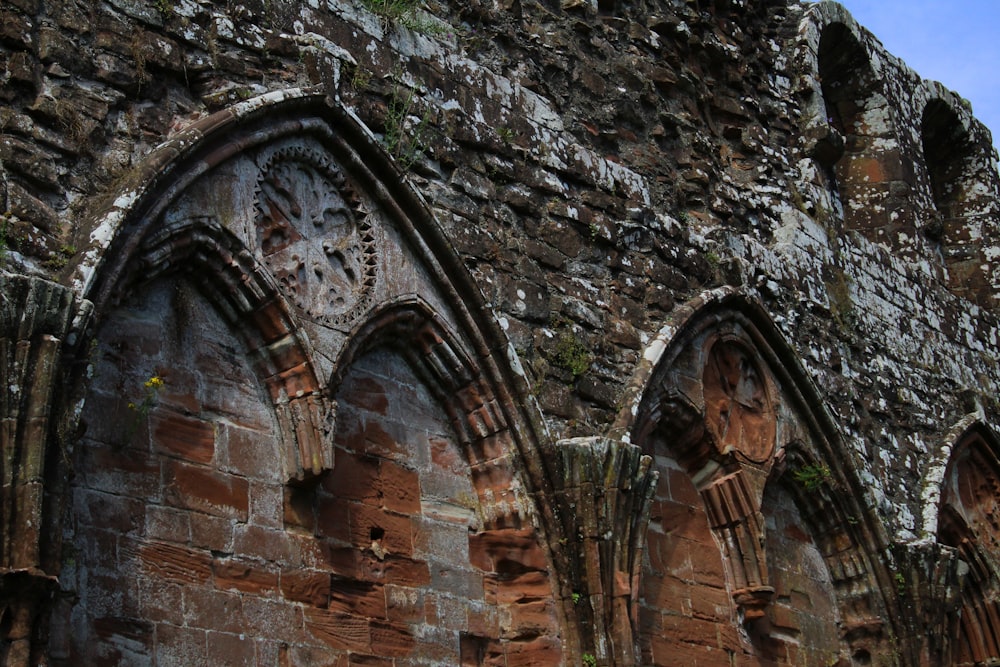 an old stone building with a clock on the side of it