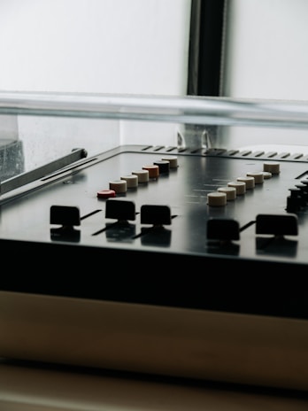 Close-up of a vintage mixing console with colorful knobs and sliders in the warehouse district studio.