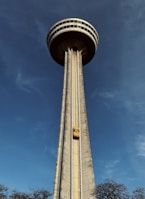 a tall tower with a train on it's side