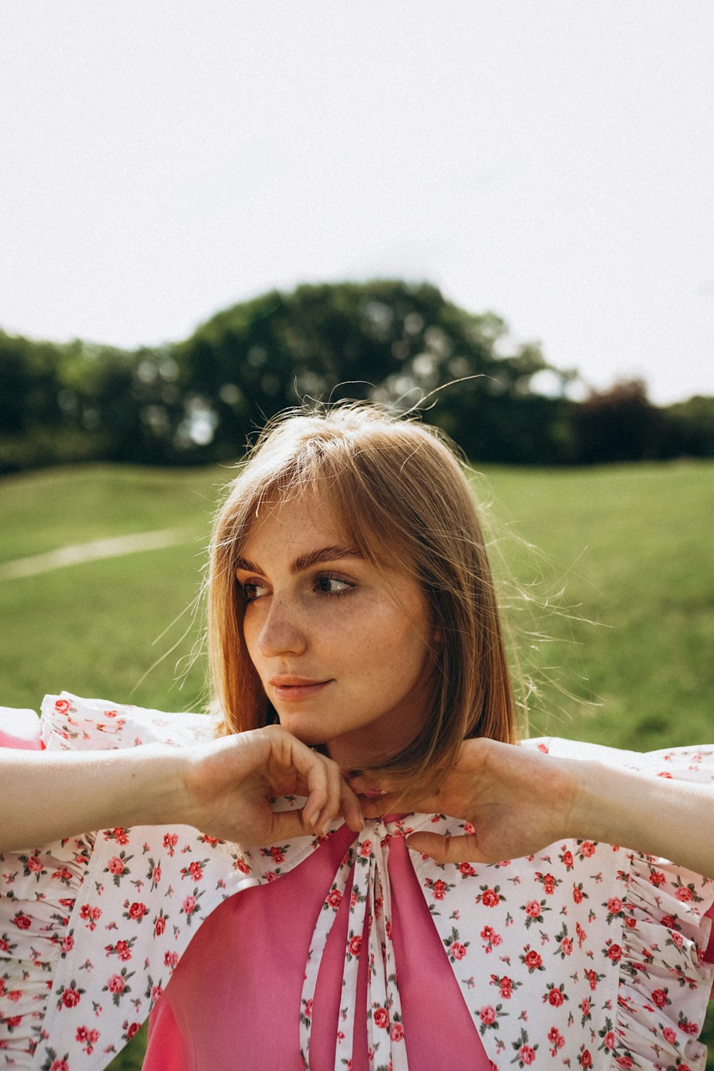 a woman with a pink bow around her neck