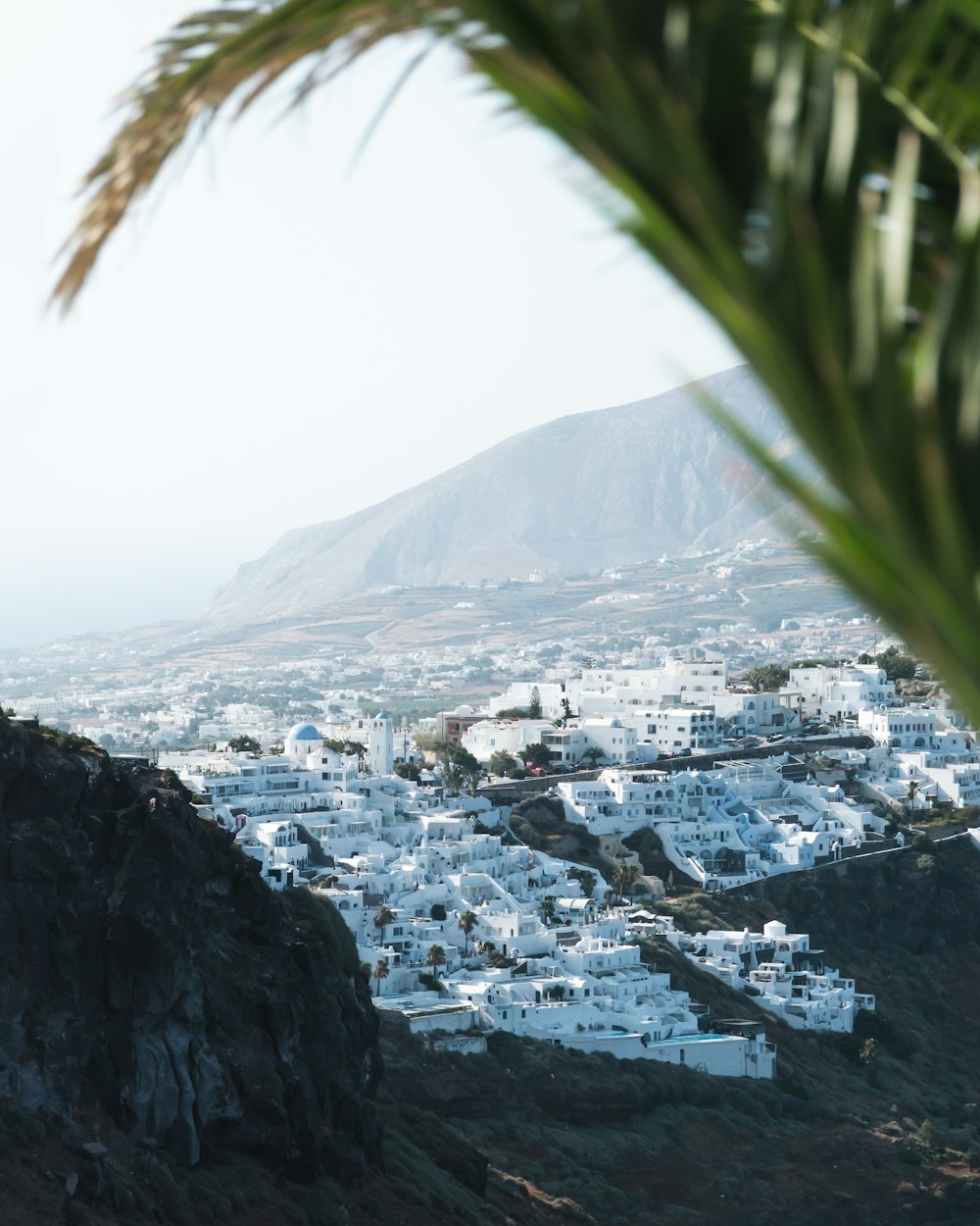 a view of a white village from a hill