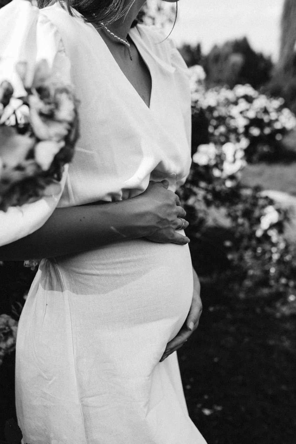 a black and white photo of a pregnant woman