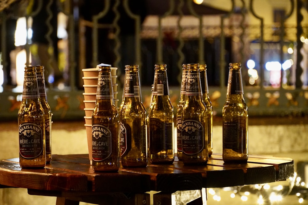 a group of beer bottles sitting on top of a wooden table