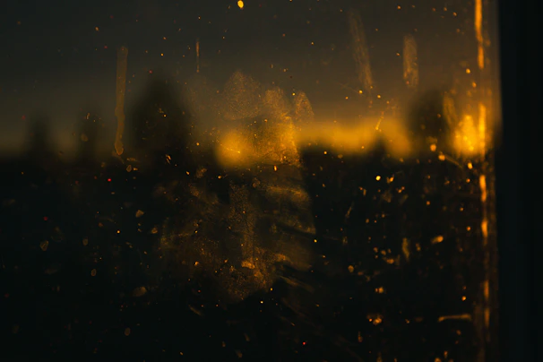 Close-up of a pristine glass window showing the contrast between dirty and cleaned surfaces.