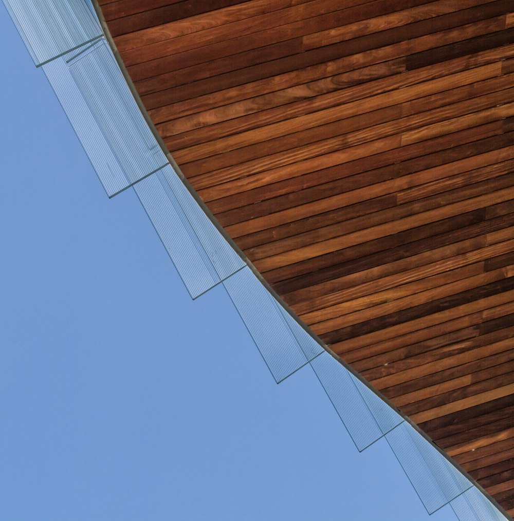 an airplane is flying over a wooden structure