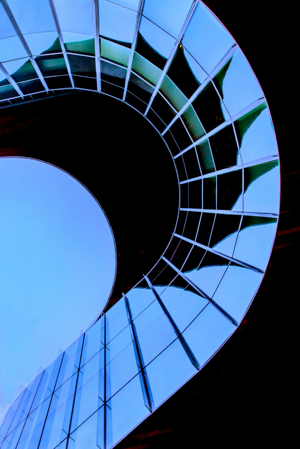 a circular mirror reflecting the sky and clouds