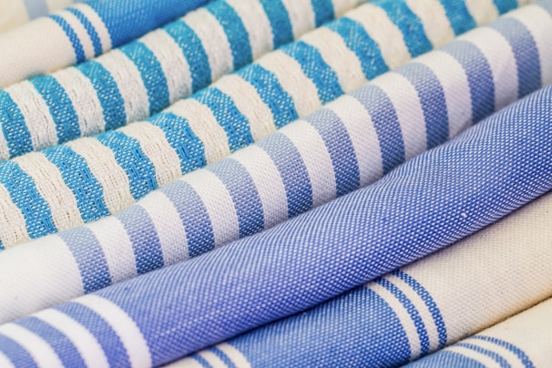 Roll of DTF printed fabric showing colorful sports-themed patterns.