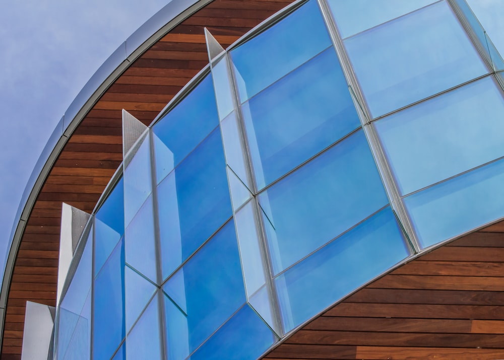 a close up of a curved building with a sky background