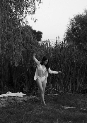 A natural outdoor setting with a model in a subtle, elegant bathing suit from Sutilia