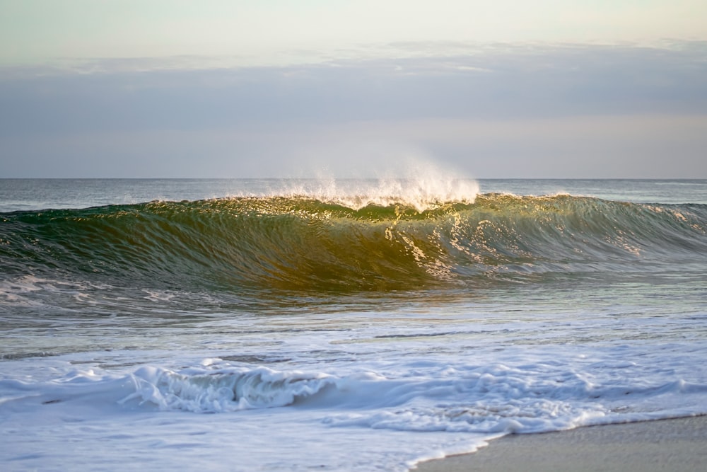 a large wave is coming in to the shore