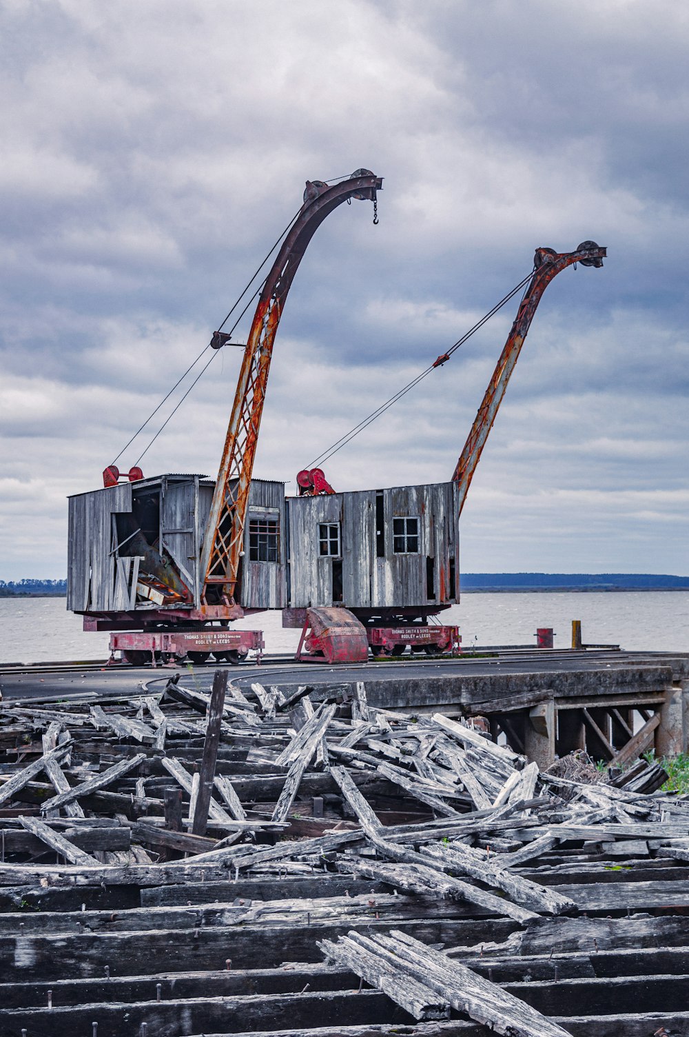 a couple of cranes that are sitting on a dock