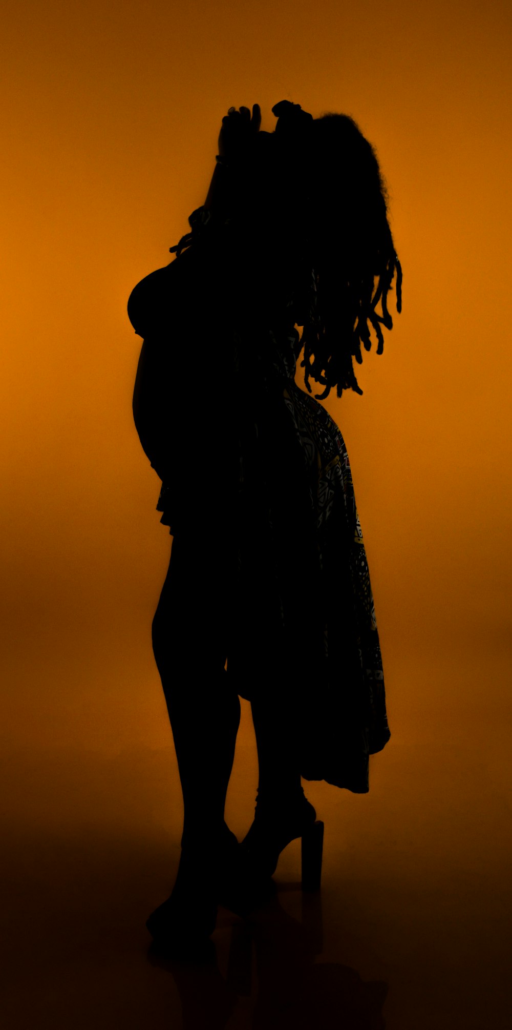 a silhouette of a woman kissing a man