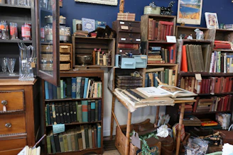 Organized shelves showcasing books, glassware, and small antiques at a recent estate sale.