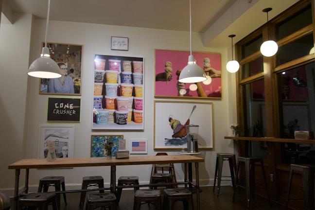 Wide angle view of the café’s industrial chic décor featuring metallic copper accents and line-art wall designs.