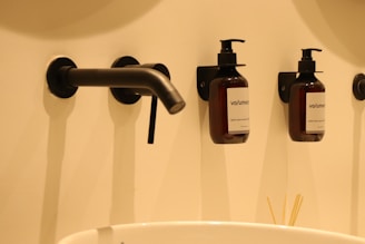 Liquid soap dispenser in a modern bathroom, highlighting smooth texture.