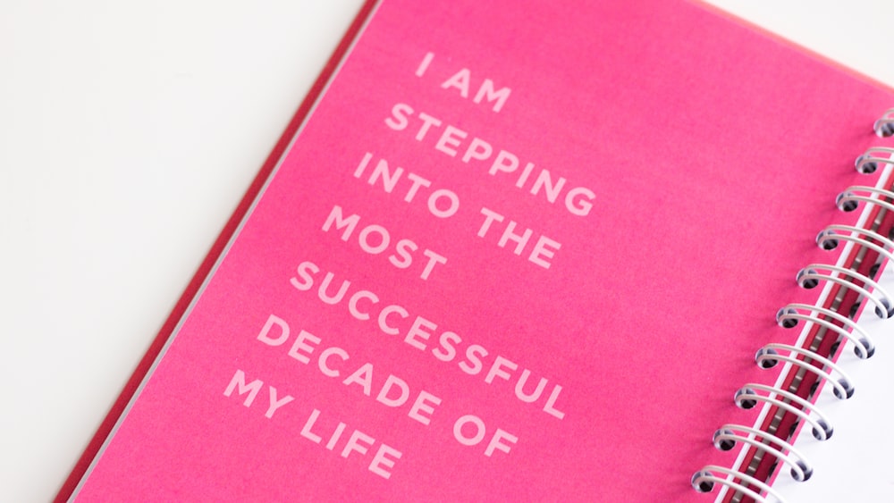 a pink notebook with a quote on it