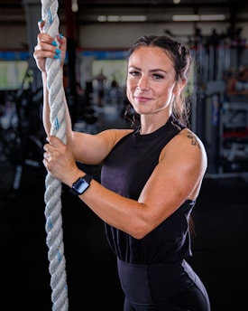 a woman holding a rope in a gym