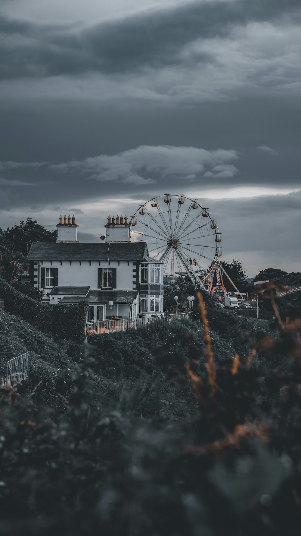 a large ferris wheel sitting next to a white house