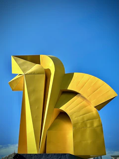 Outdoor metal sculpture featuring intricate welding and bold geometric shapes