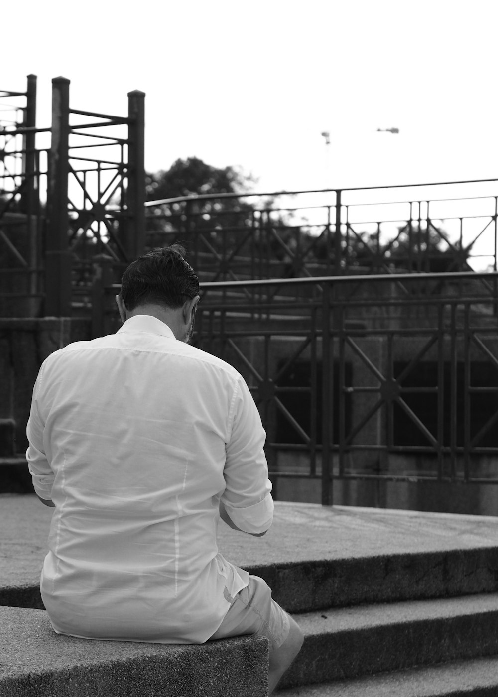 a man sitting on steps talking on a cell phone