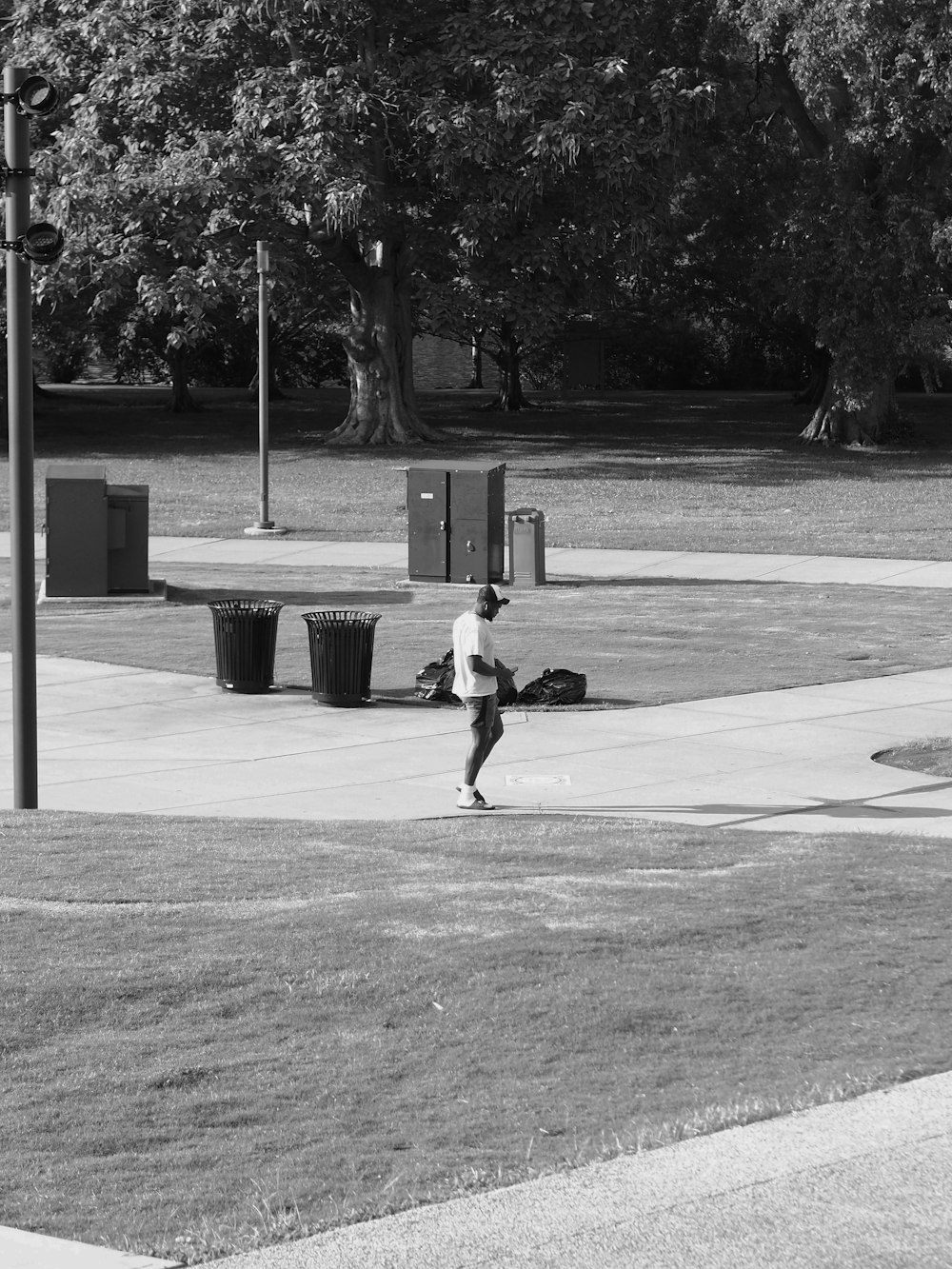 a man riding a skateboard down a sidewalk