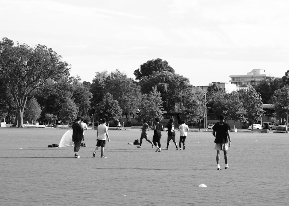 a group of people standing on top of a field