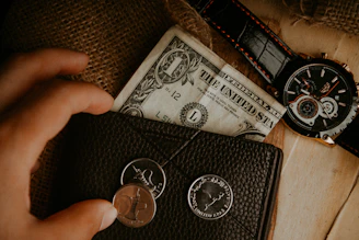 Close-up of hands exchanging money with Islamic finance documents on the table.
