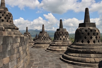 a group of stone structures sitting on top of a stone wall