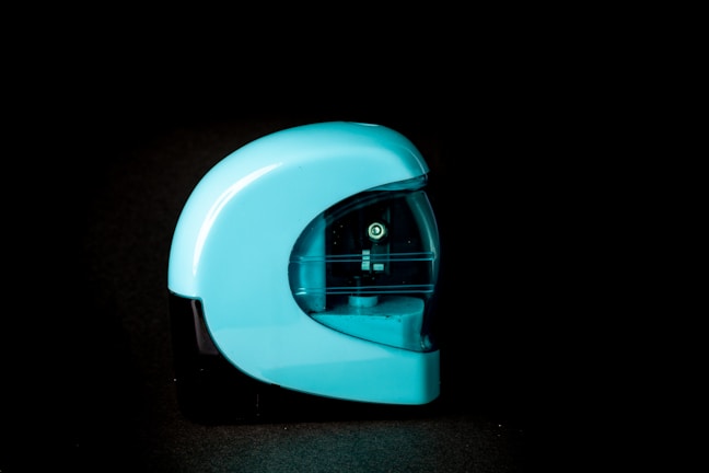 A sleek kitchen gadget with metallic blue accents glowing under soft lighting.