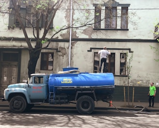 a blue truck parked on the side of a road