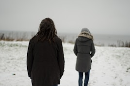 a couple of people standing in the snow