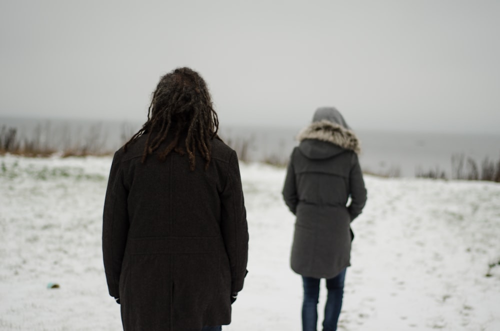 a couple of people standing in the snow