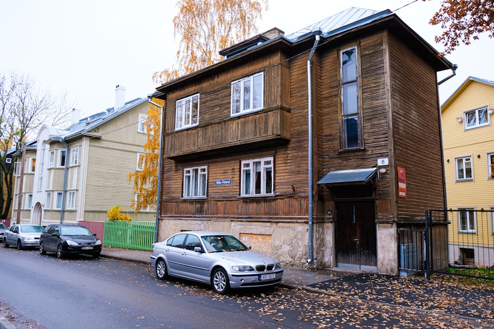 a car parked in front of a wooden building