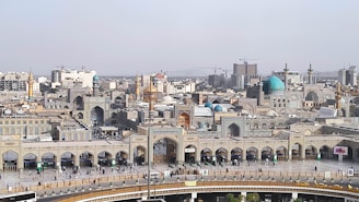 A panoramic view of the urban development plan for Madinat Omra showcasing green spaces and modern buildings.