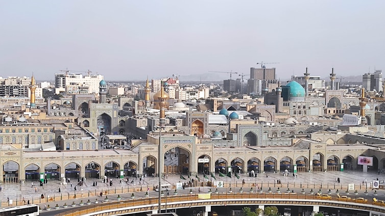 A panoramic view of the urban development plan for Madinat Omra showcasing green spaces and modern buildings.
