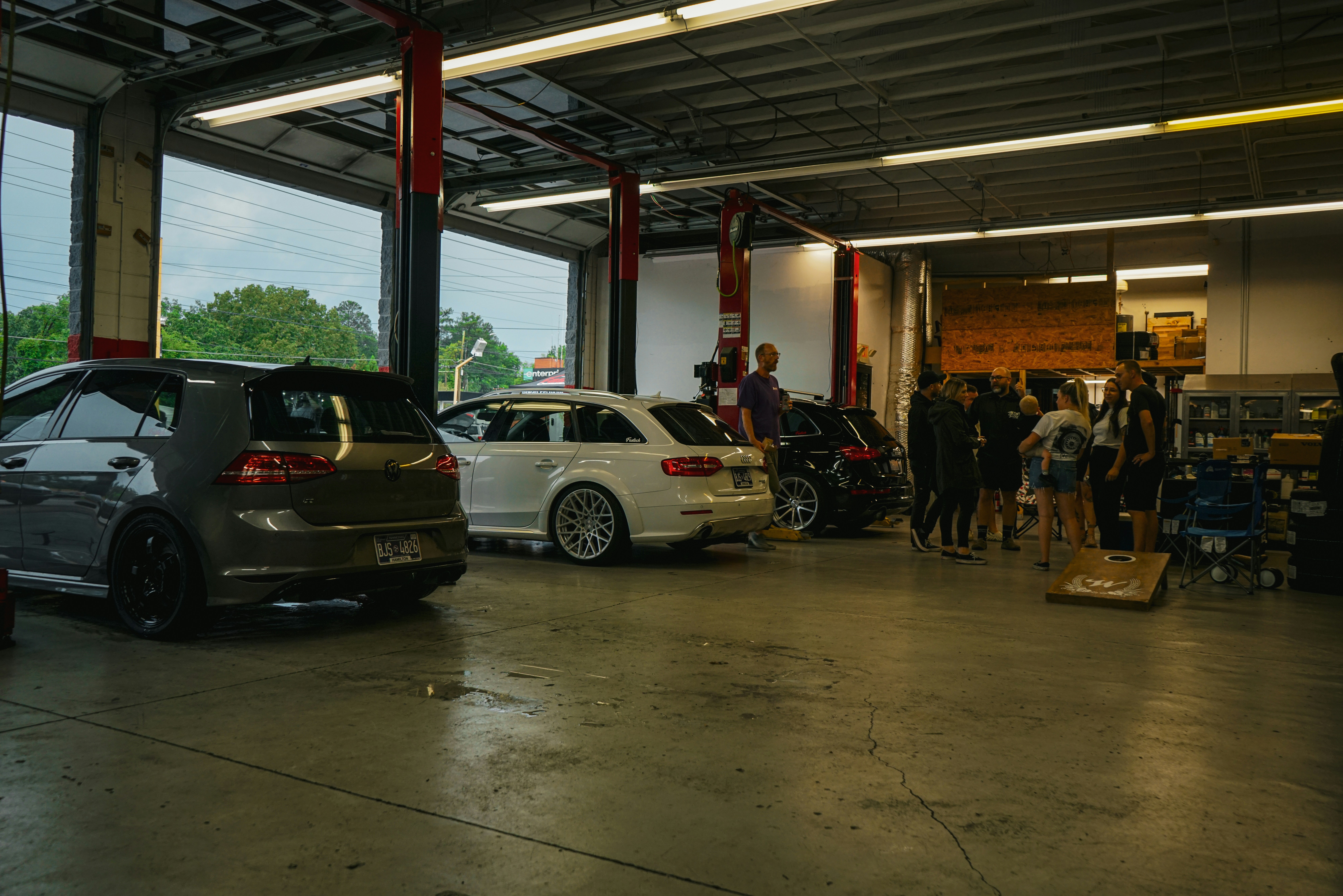 Family reviewing a used car with a sales consultant in a dealership setting