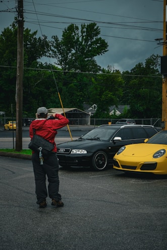 a man standing in the middle of a parking lot