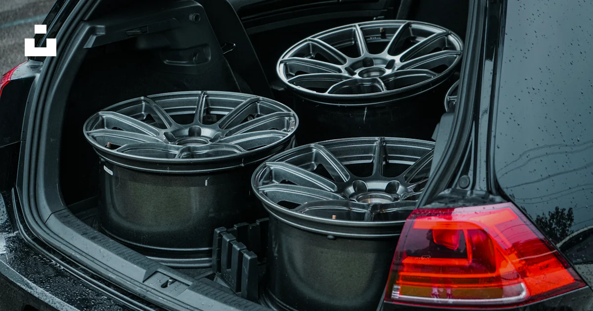 Behind Car Rim The back of a car with a bunch of wheels in it photo – Free Image on ...