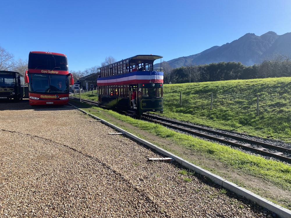 a couple of buses parked next to each other on the side of a road