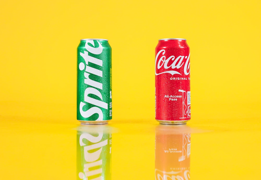 a couple of soda cans sitting on top of a table