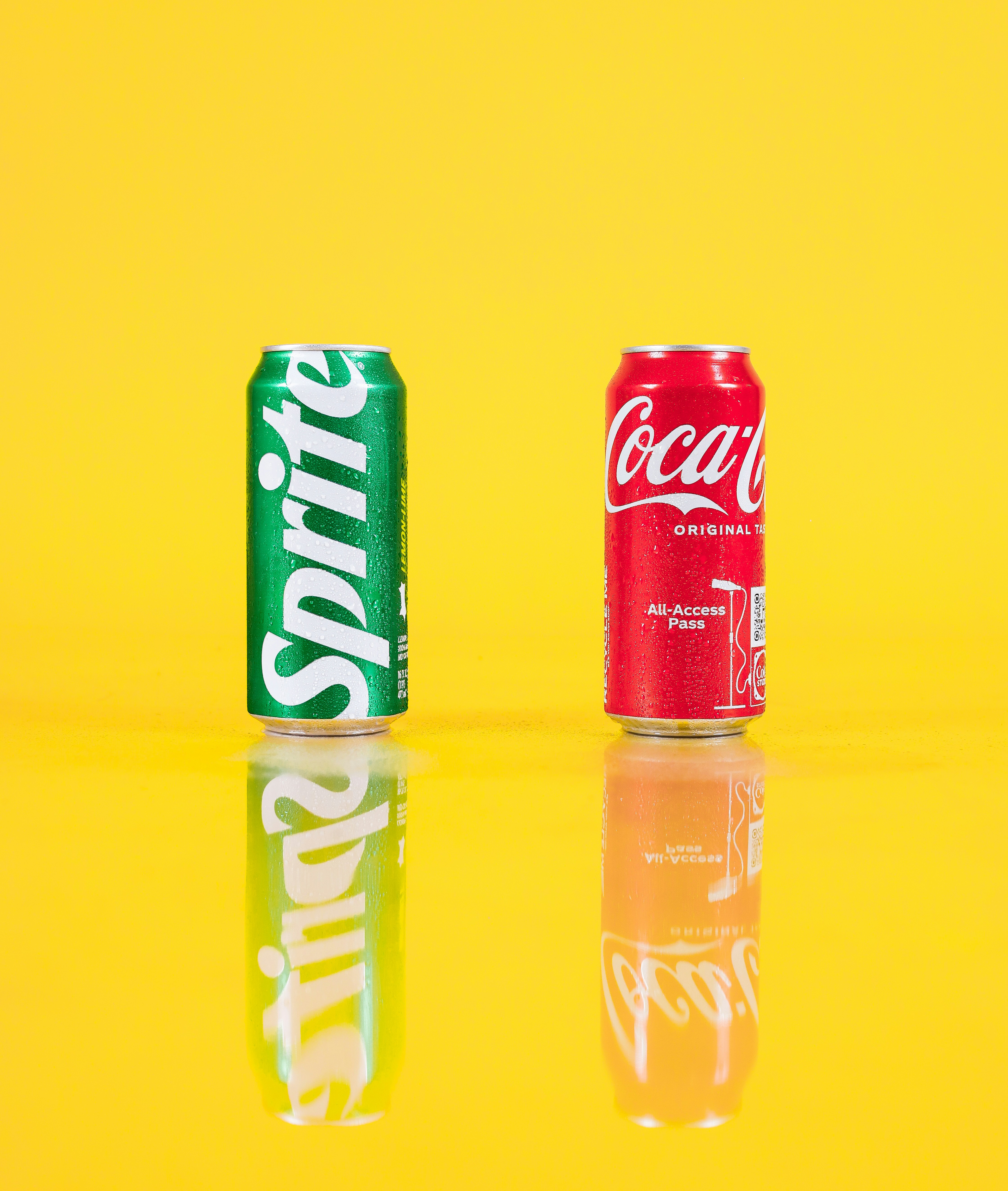 a couple of cans of soda sitting on top of a table