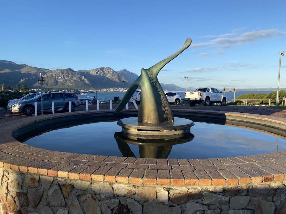 a fountain with a statue in the middle of it