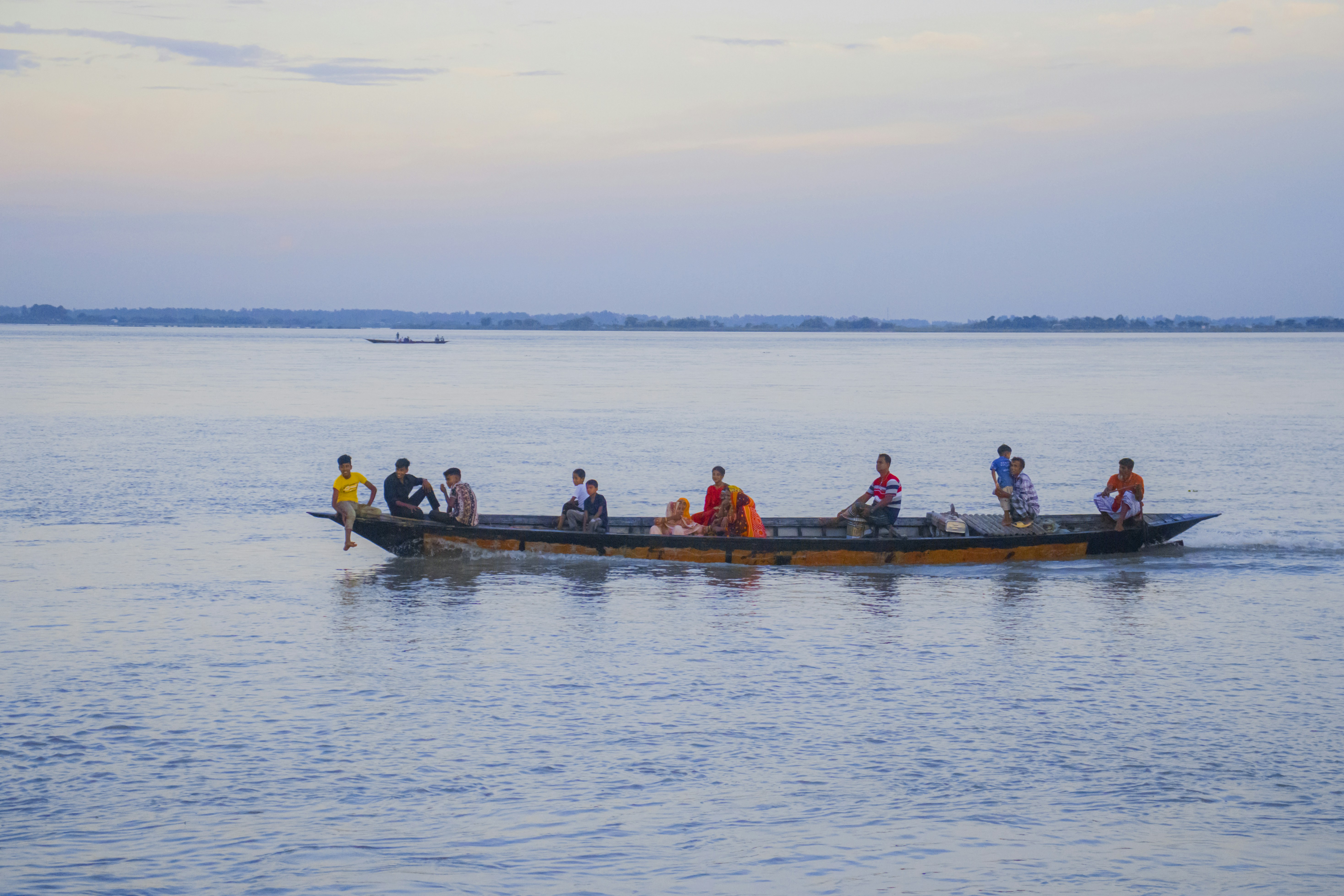 A group of people riding on the back of a boat photo – Free Enayetpur ...