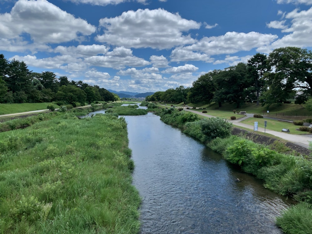 a river running through a lush green countryside