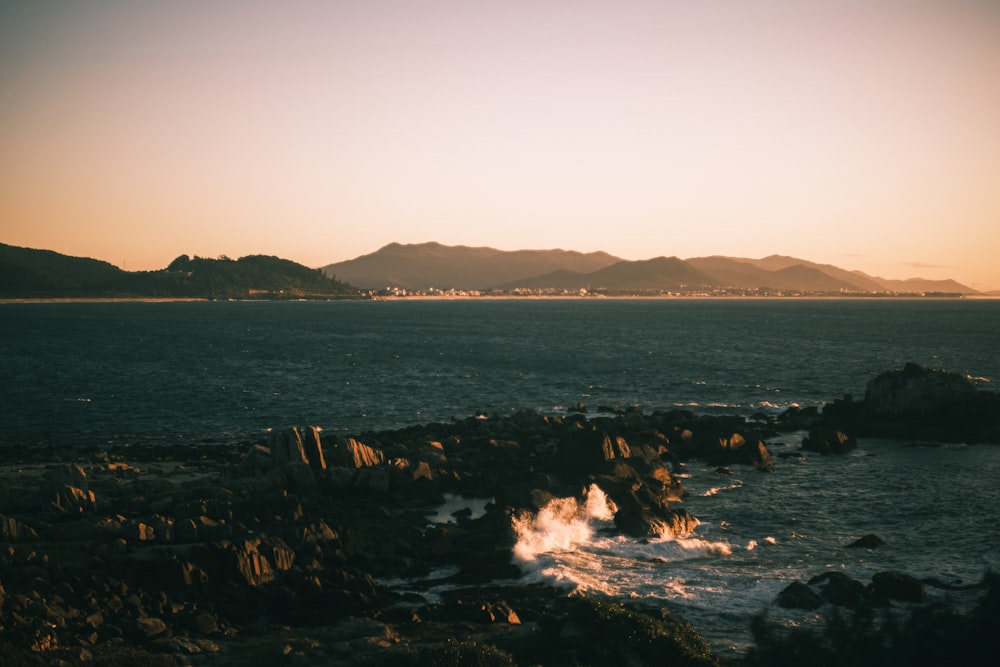 a body of water near a rocky shore