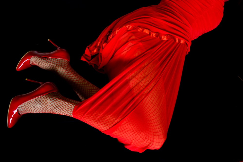 a woman in a red dress and high heels