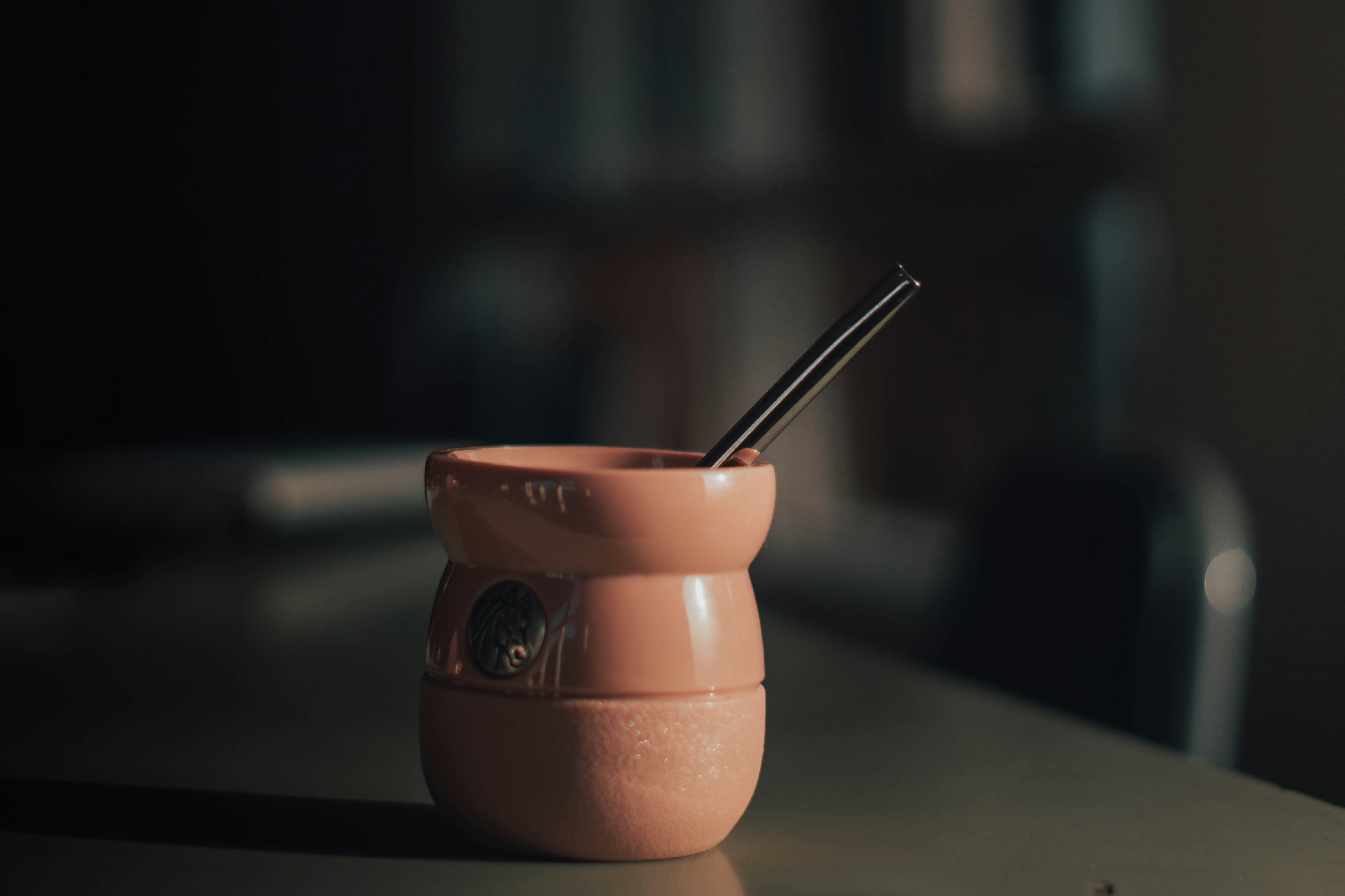 a cup with a straw in it sitting on a table